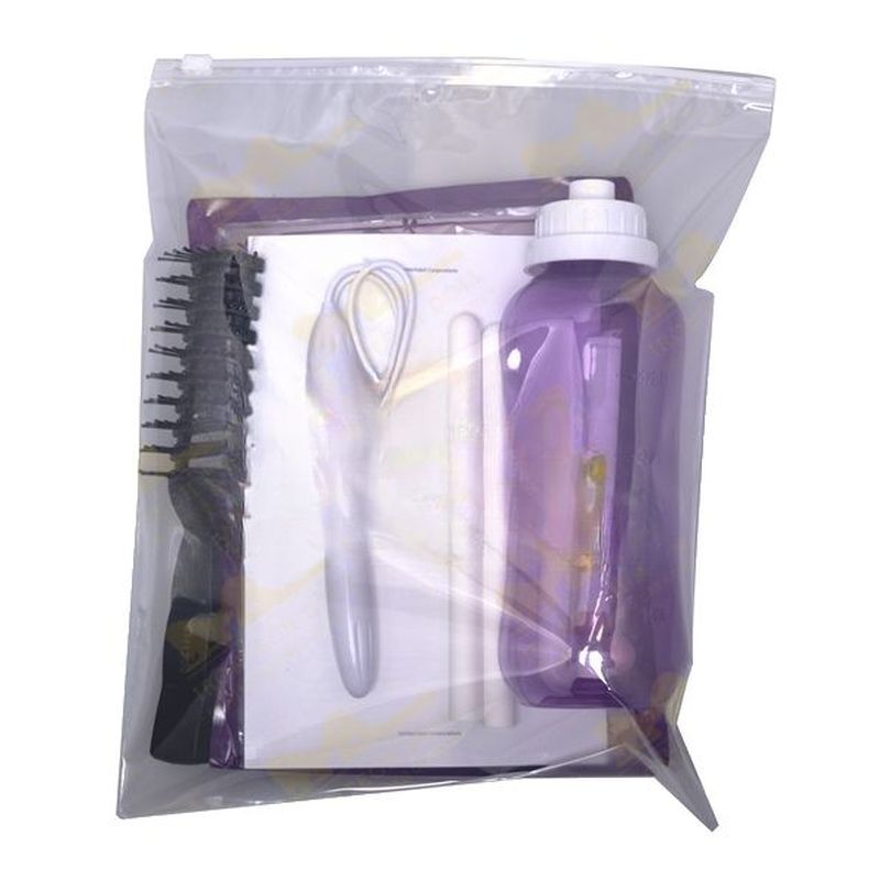 Set of hair care products including a bottle, comb, and brush in a clear package on a white background