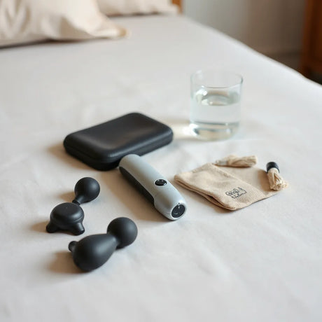 Discreet pleasure products arranged neatly on a bedside table with warm, natural lighting