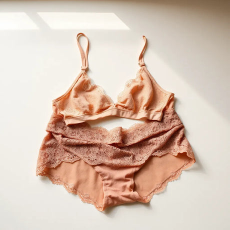 Lace bralette and matching high-waist lingerie set arranged under soft natural light on a neutral surface