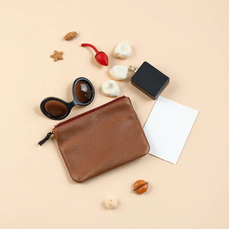 Assorted adult novelty accessories arranged neatly on a neutral tabletop with a small travel pouch