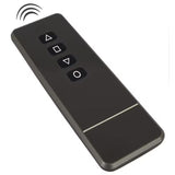 A black wireless remote control with four white geometric buttons and a signal icon at the top.