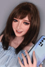 smiling sex doll holding a smartphone with a neutral background